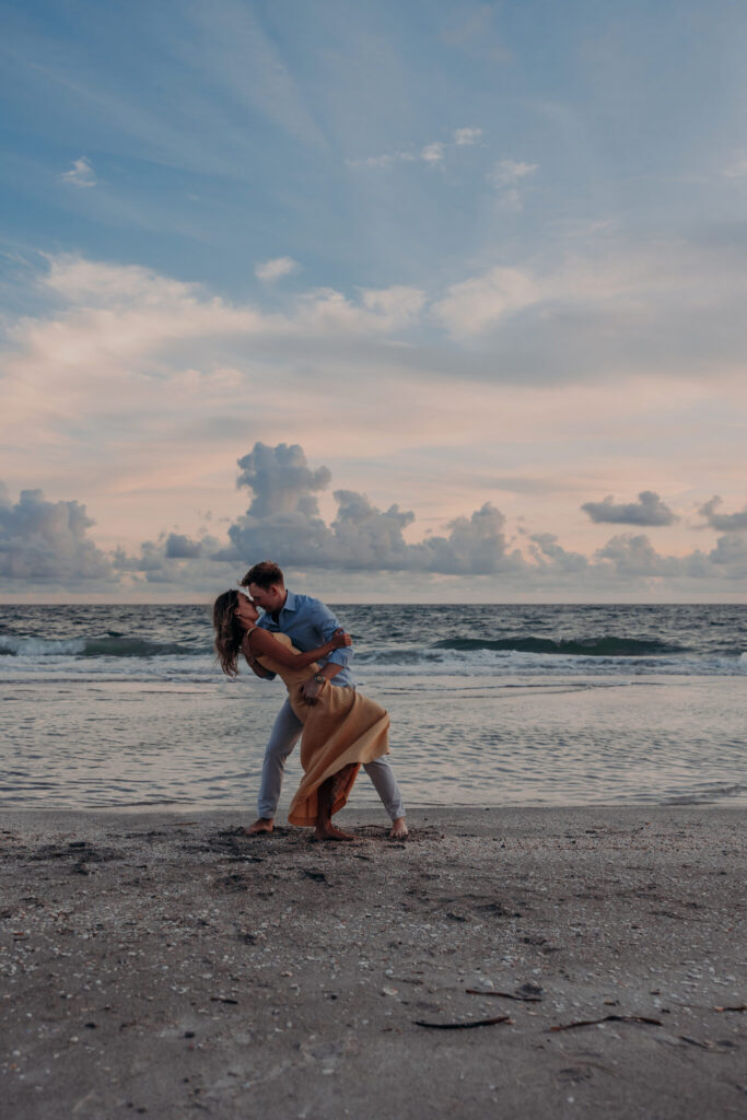 Michael and Regan share a kiss on the beach at sunset, Longboat Key, FL