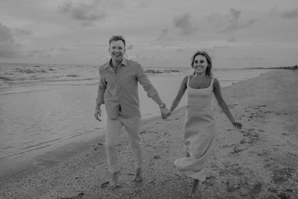 Black and white portrait of Michael and Regan embracing on the beach