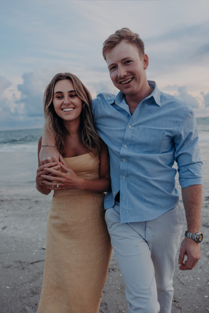 Regan looks down at her new engagement ring after Michael's surprise proposal