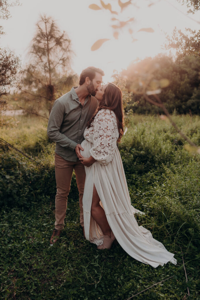 Kate and Warren embracing during their maternity session